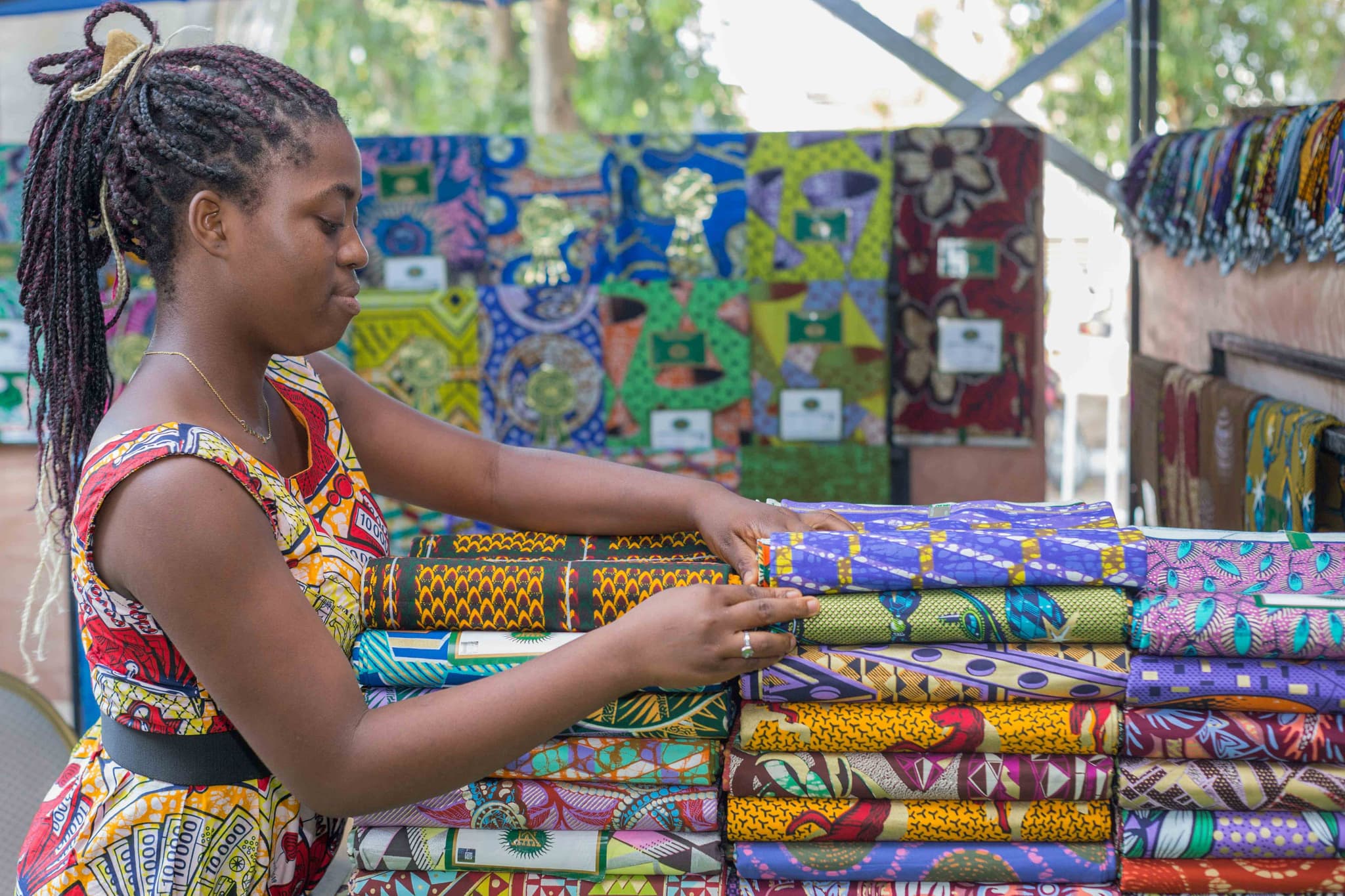 Ankara fabric seller showcasing products