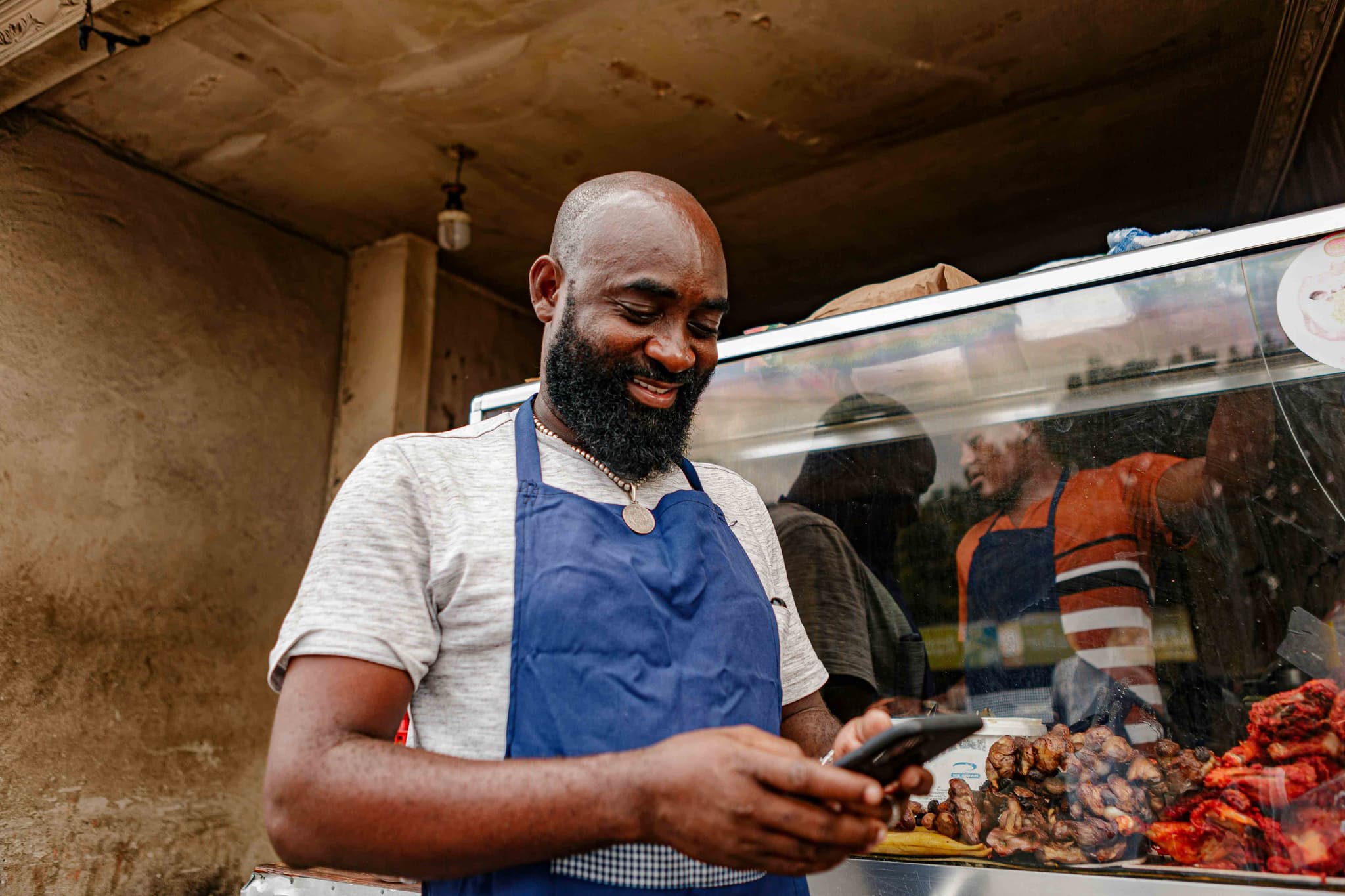 Food vendor receiving order notification on phone